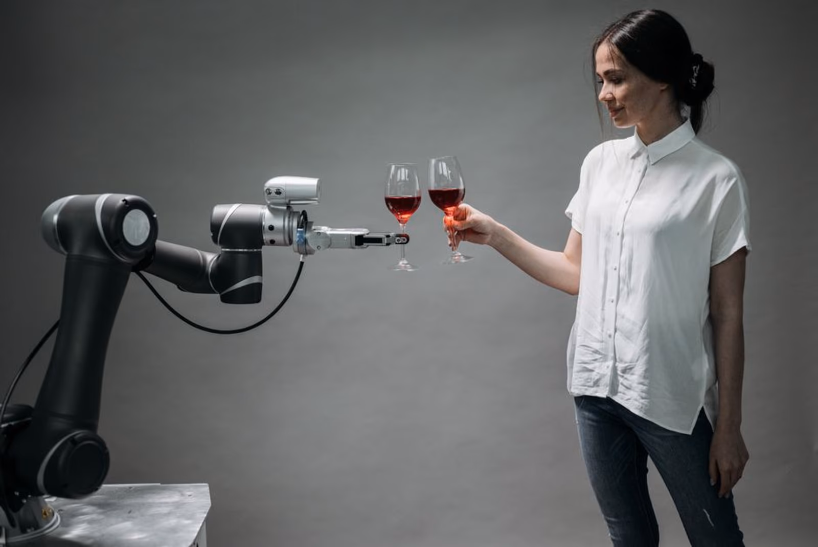 A human hand and a robotic hand exchanging a glowing task card, symbolizing AI-to-human handoff logic