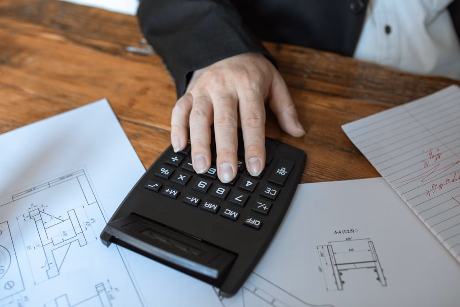 Person reviewing ROI calculation spreadsheet with charts on a laptop