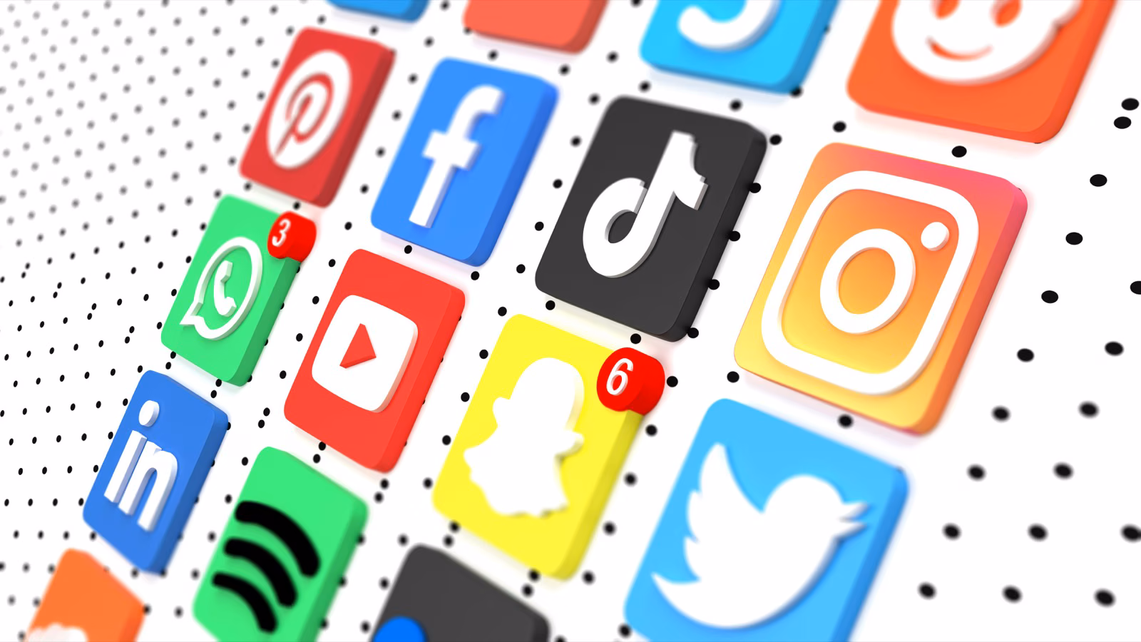 Designer iterating on app icon variants on a desktop with mobile previews shown across multiple devices.