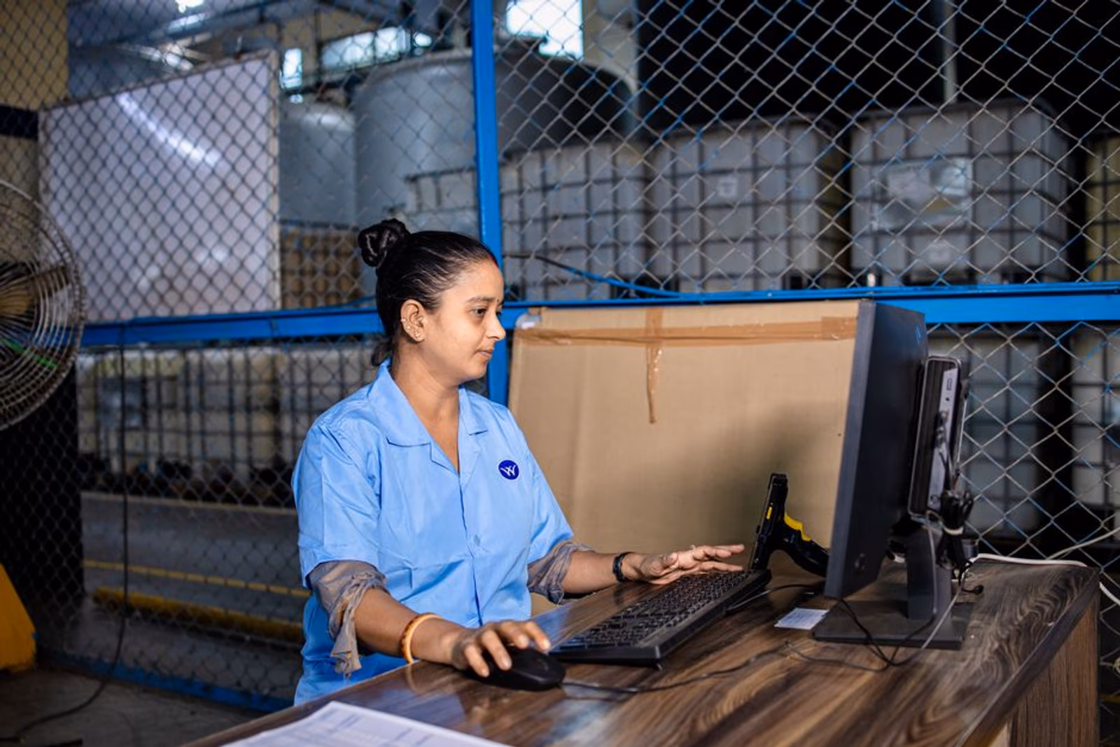 Small operations team reviewing automated weekly reports on a laptop in a modern office