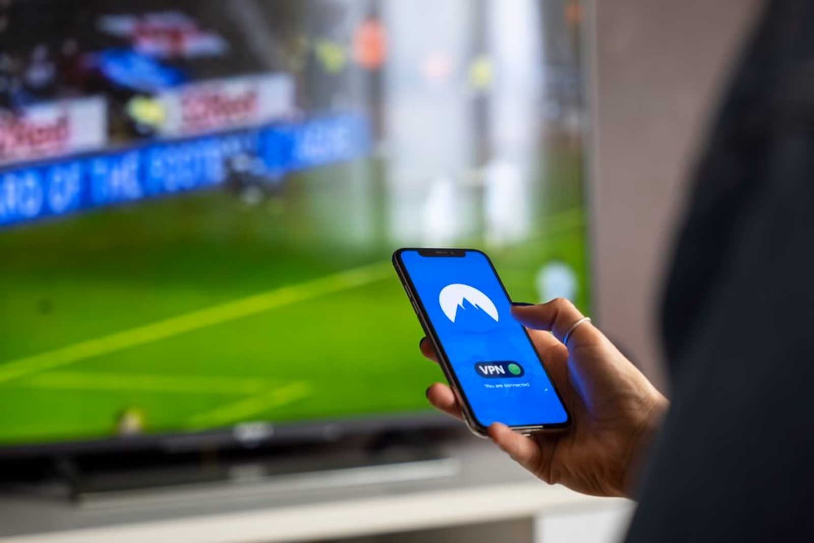 A living room smart TV displaying a streaming interface, representing connected TV advertising for mobile app user acquisition