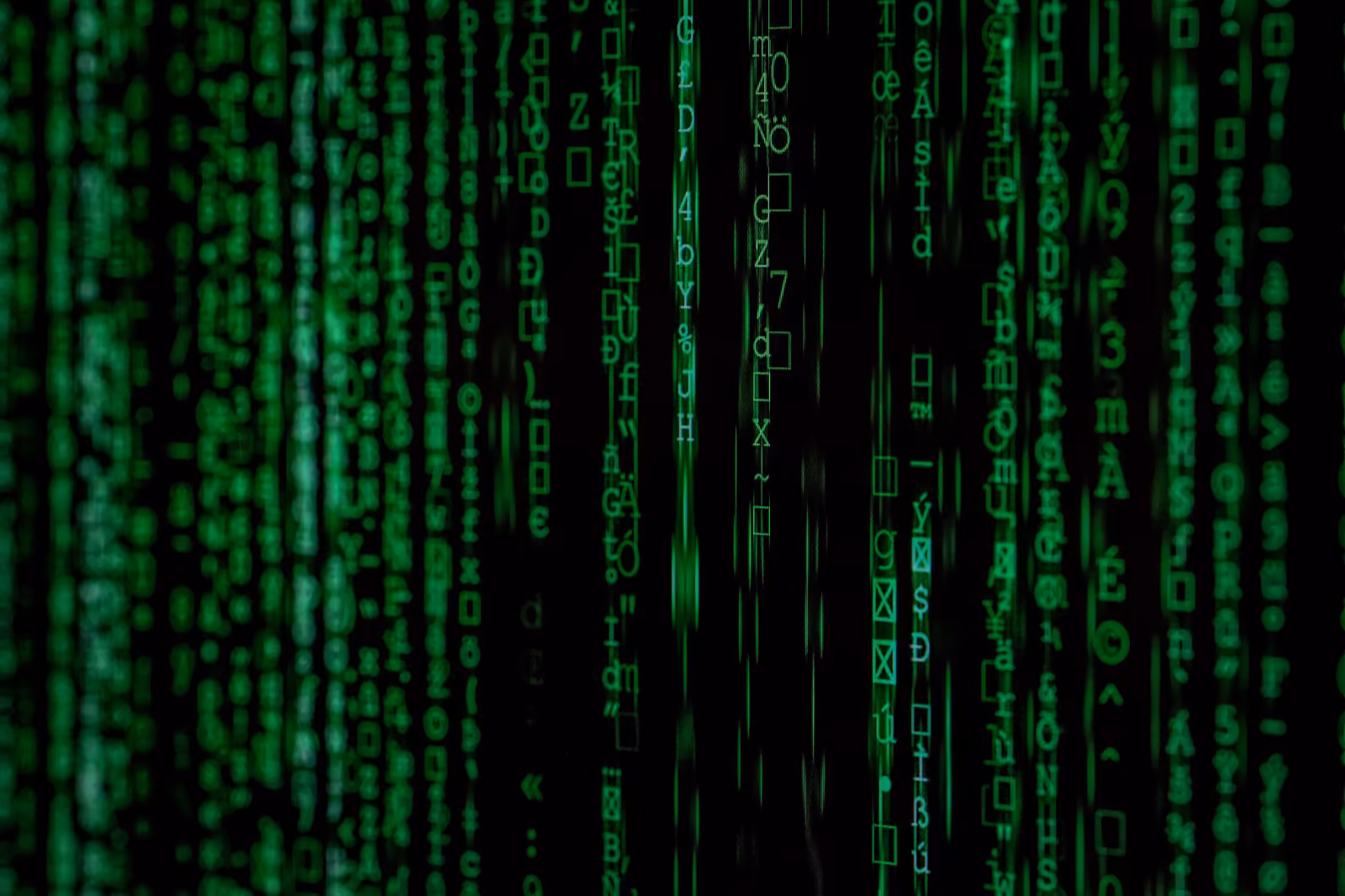 Green Matrix-style code on a black background — the visual of data security and compliance work.