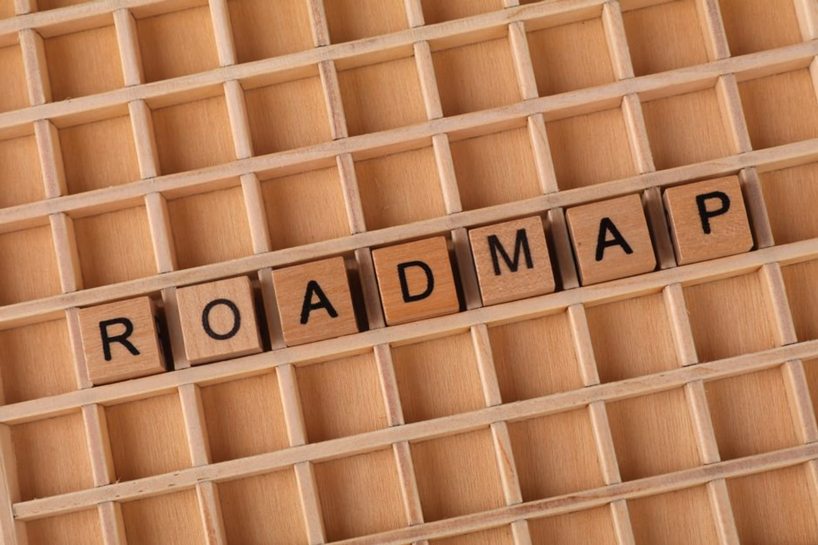 A product roadmap on a whiteboard with sticky notes organized into 30-day sprint columns