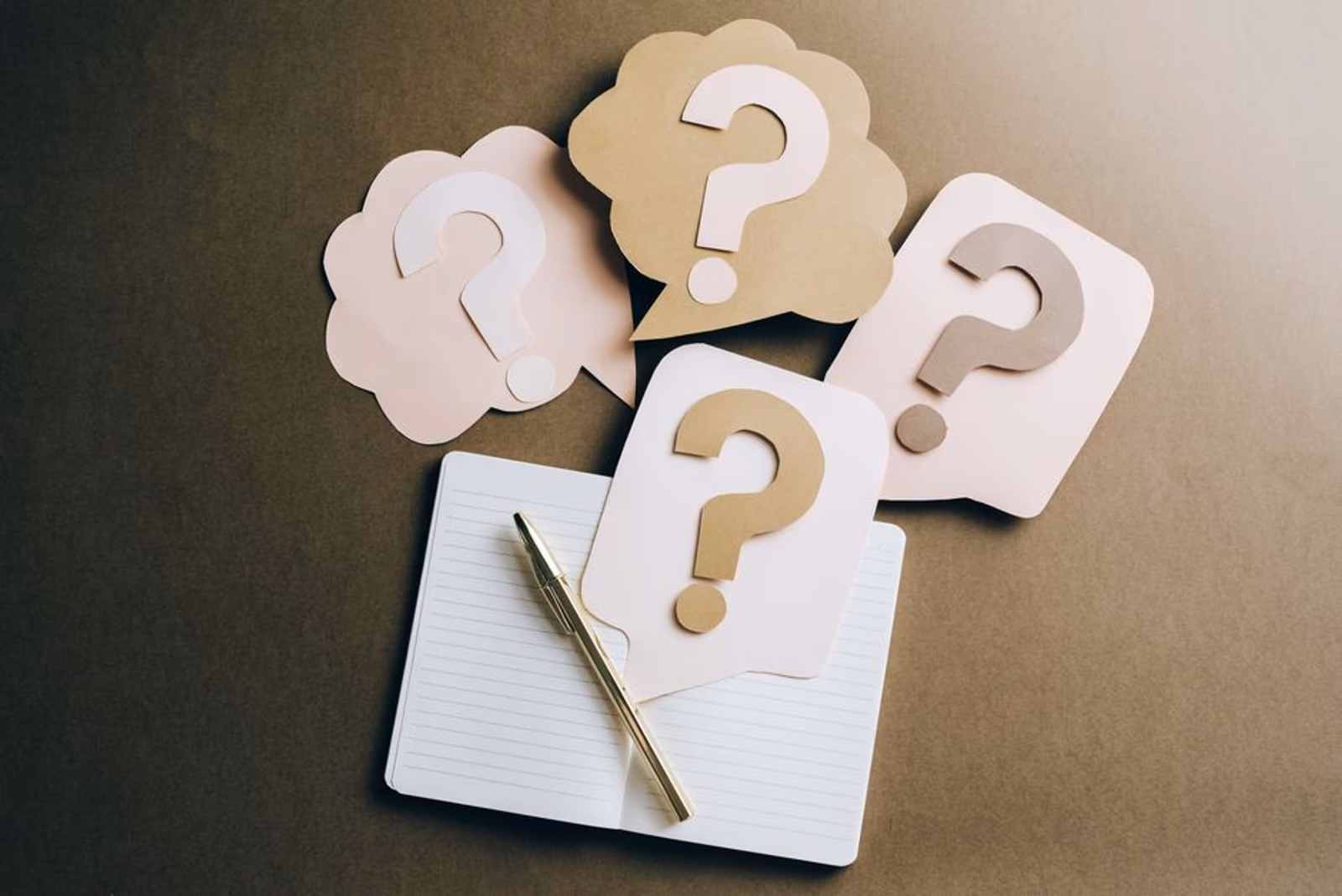 A person writing FAQ content on a laptop, optimized for AI engine citations