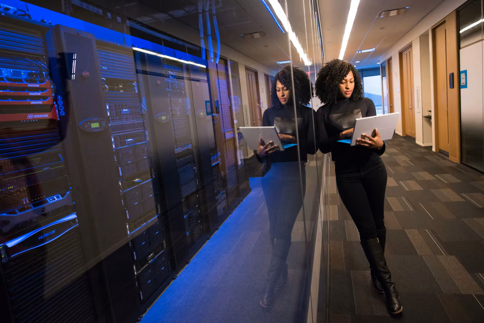 A focused engineer reviews a tablet in a server room — executing on the SEM Nexus playbook.