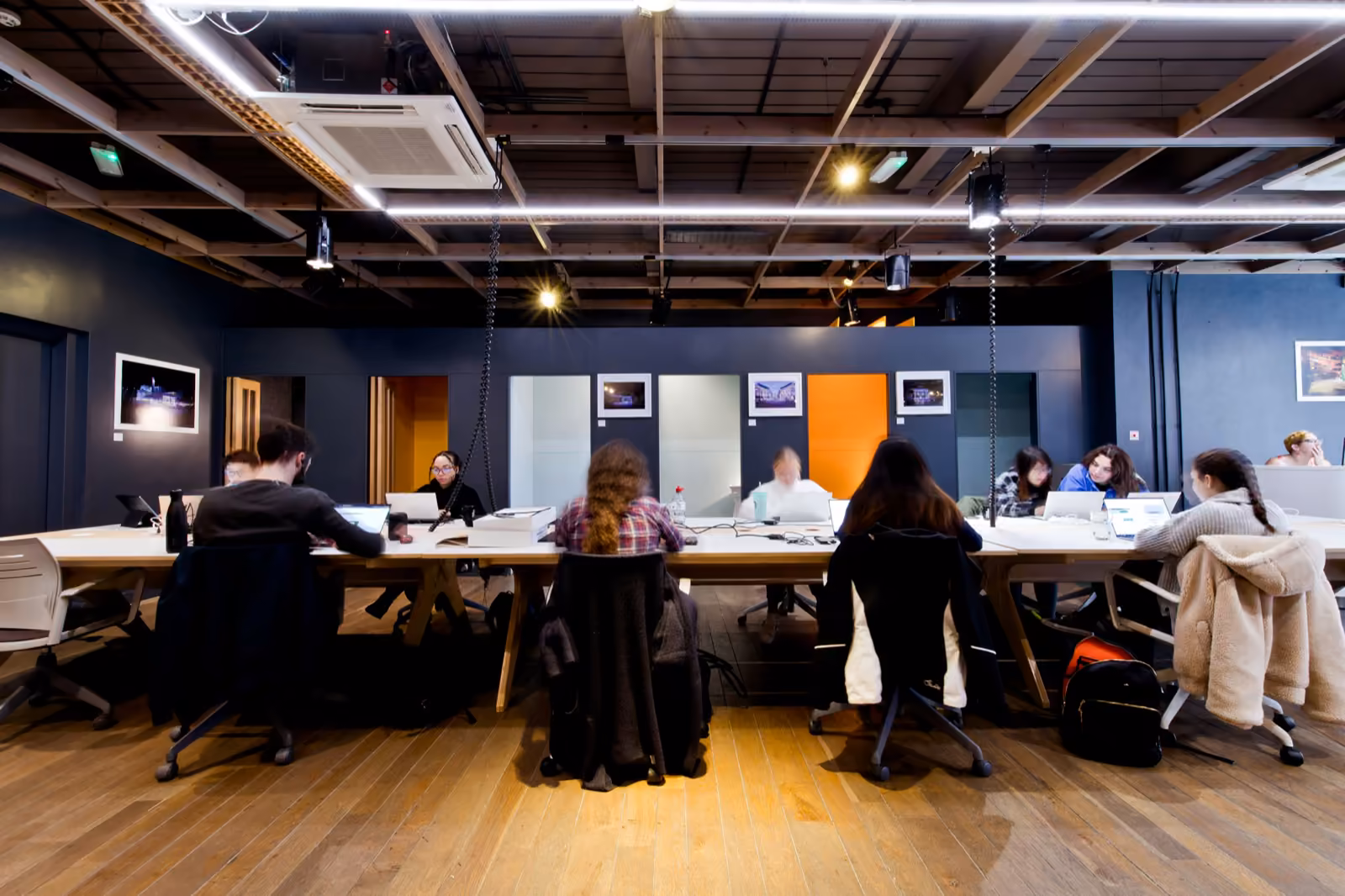 A coworking space with people at desks — the two-sided coordination of a marketplace.