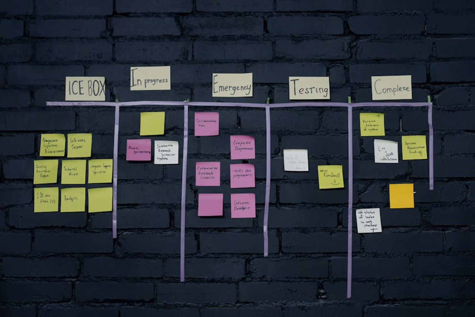 Designer reviewing multiple app ad creative variants on a large monitor in a marketing workflow