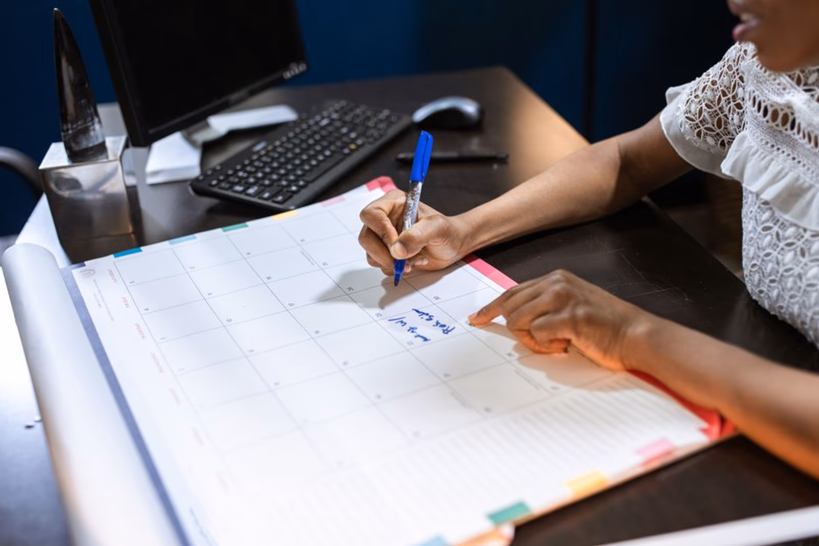 A marketing calendar spread across a desk with highlighted seasonal peak dates and budget planning notes