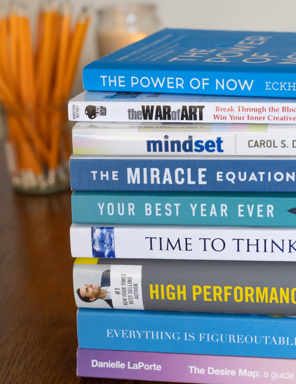 A stack of productivity books — the visual of disciplined auditing.