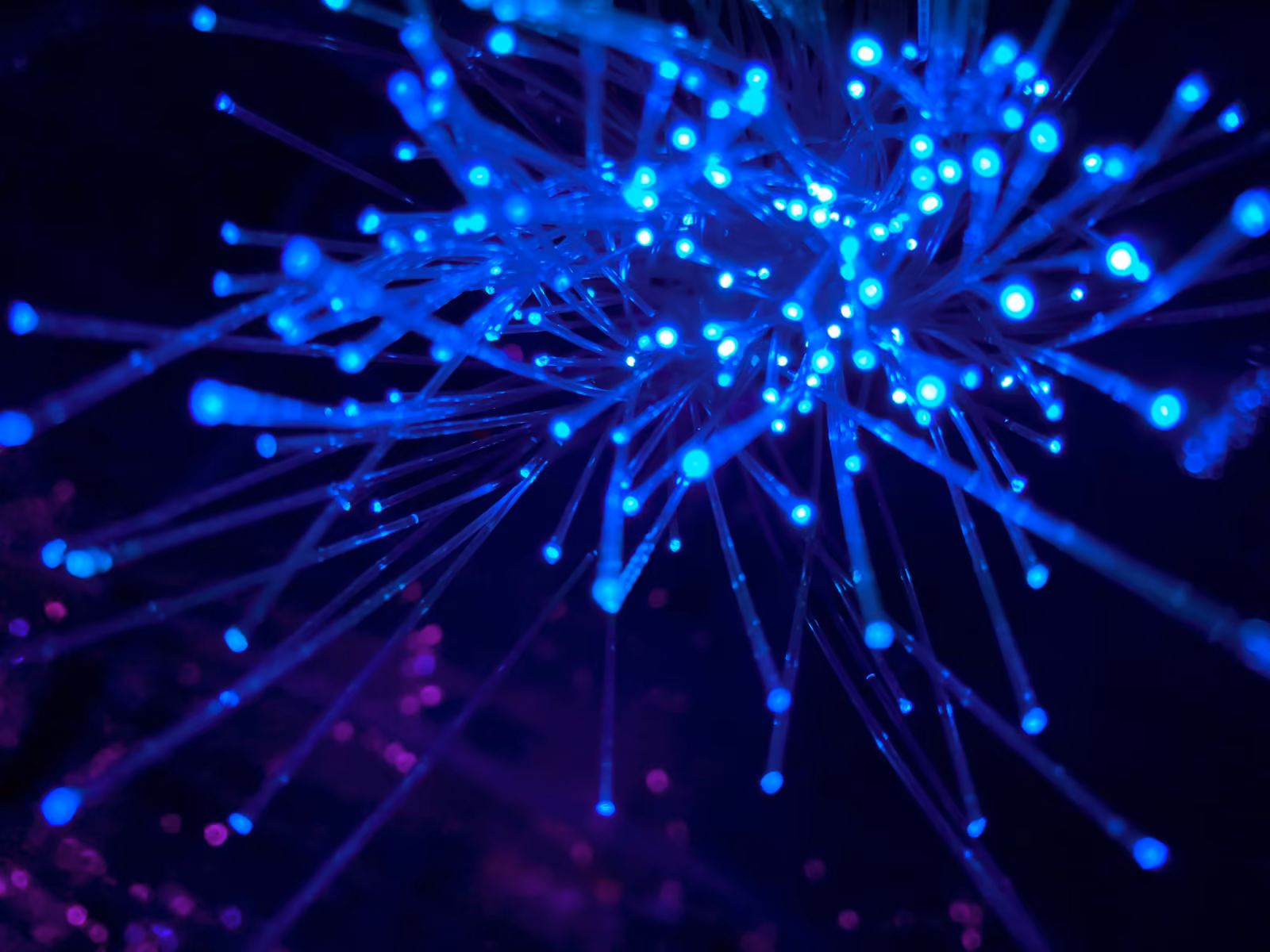 Blue fiber-optic LED burst — many ideas converging into focus during a discovery engagement.
