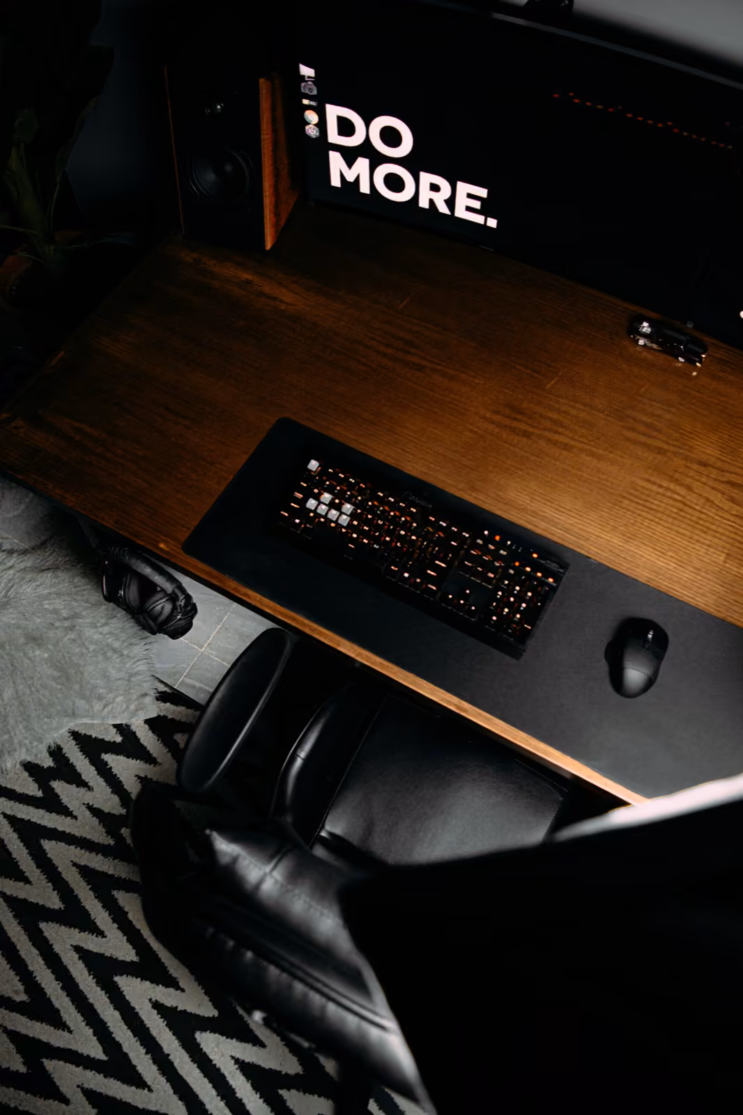 A focused desk with a DO MORE sign — the visual of disciplined execution against scope.