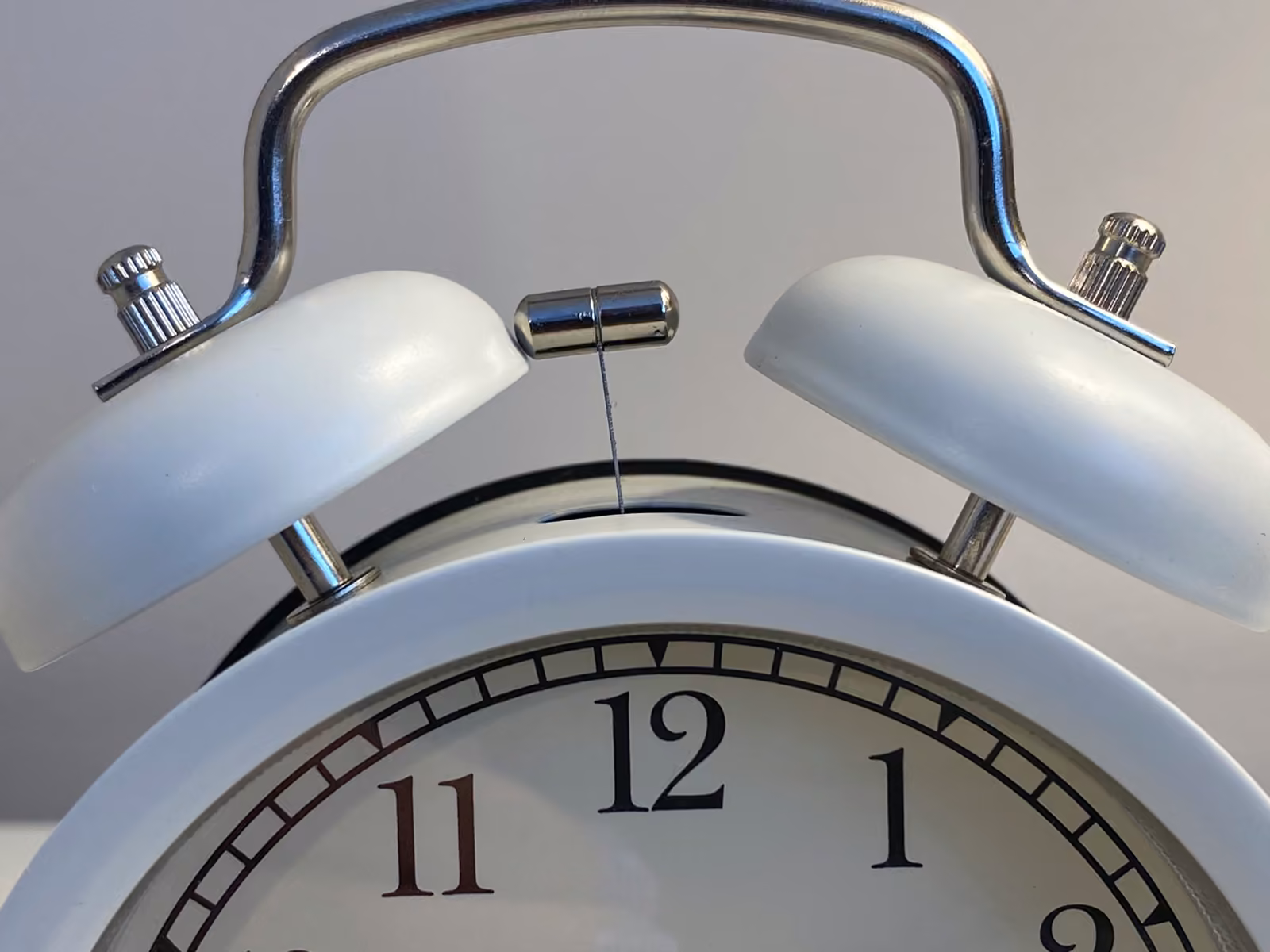 A vintage analog alarm clock — the visual of compressed timelines and disciplined delivery.